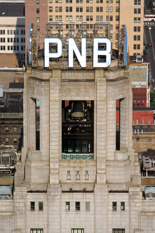 PNB Building crown with signs. Photo by Bradley Maule