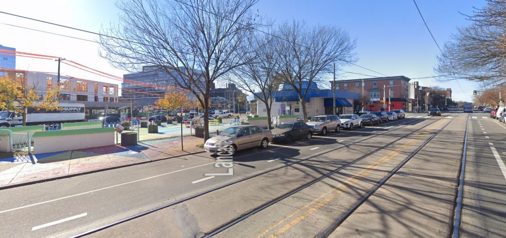 Looking southwest from in front of 3729-31 Lancaster Avenue, with uCitySquare visible in the background on the left and Penn Presbyterian Medical Center on the right. November 2020. Credit: Google Maps