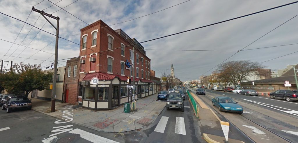 310-30 West Girard Avenue, with the #rd & Girard bar on the left and a stop of the Route 15 trolley on the right. Looking southeast. October 2016. Credit: Google Street View