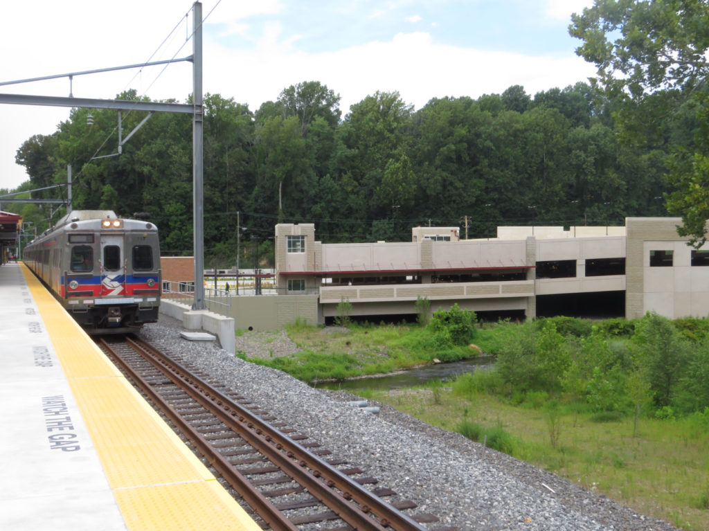 A train sits at the platform with the garage in the background. Credit: Colin LeStourgeon.